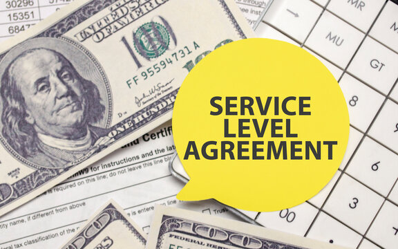 SERVICE LEVEL AGREEMENT on yellow sticker with pen and calculator