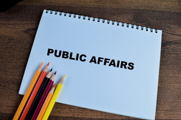 Concept of Public Affairs write on book isolated on Wooden Table.
