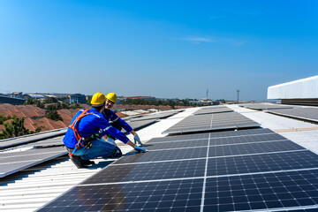 Solar engineer men talking while installing solar panels on factory roof