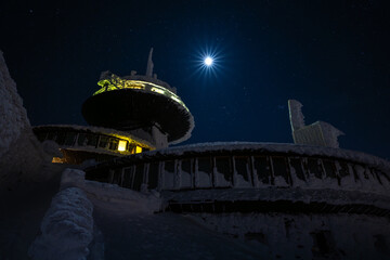 peak of Sniezka mountain at full moon night during in Giant mountains during winter - 701850289