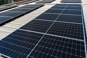 Close up solar panels on factory roof, green energy concept