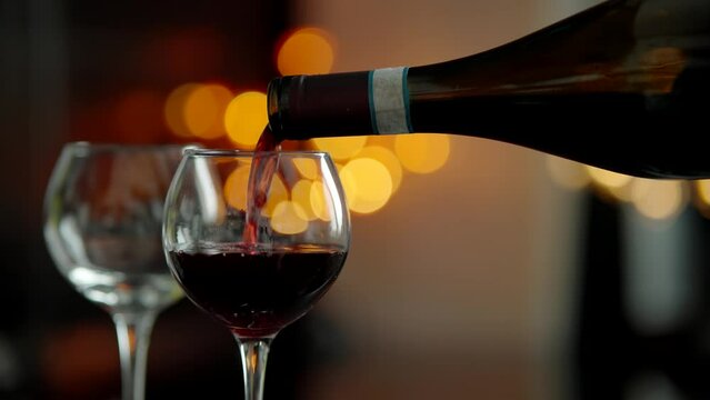 Winemaker tasting flavor and quality . Pouring red wine into goblet 