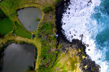 Aerial top view of Senneville waterfall and waves crashing on the south coast of Mauritius island