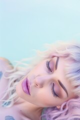 Soft focus portrait of a young woman peacefully sleeping with a pastel pink hairstyle