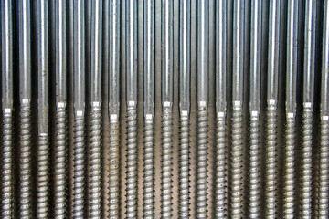 Fasteners. Metal screw screws on an iron background