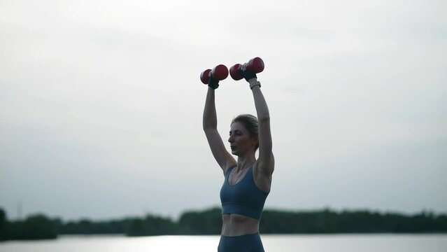 woman exercising outdoors to train muscles and improve strength	