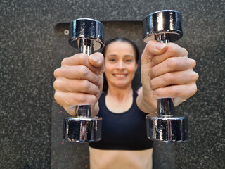 Beautiful fitness woman with dumbbells