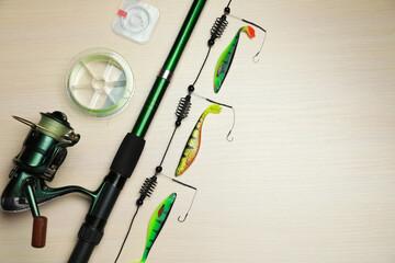 Fishing tackle on wooden background, flat lay. Space for text