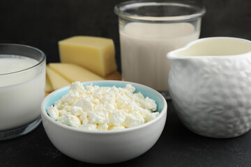 Lactose free dairy products on black textured table, closeup