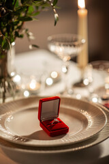 engagement ring in red box on served table