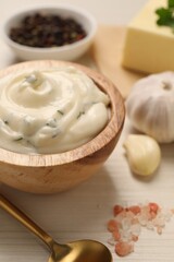Fototapeta na wymiar Tasty sauce with garlic and ingredients on white wooden table, closeup
