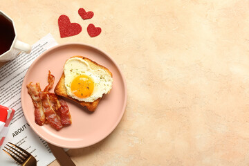 Composition with tasty bacon, fried egg, toast, cup of tea and newspaper on beige background