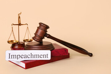 Word IMPEACHMENT, judge gavel, scales of justice and law books on beige background
