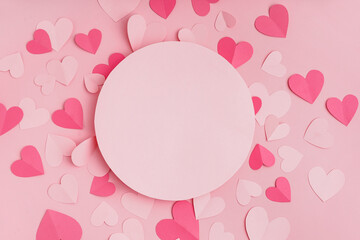 Blank card with paper hearts on pink background. Valentine's Day celebration