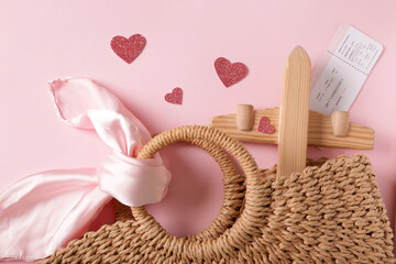 Bag with hearts, wooden airplane and ticket on pink background. Valentine's Day celebration - obrazy, fototapety, plakaty