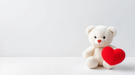 White teddy bear with red heart on white background. 