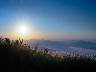 Scenic view of sea of clouds around mountain peaks at sunrise at Phu Chi Fa in Chiang Rai,Thailand.
