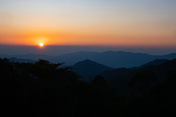 Scenic view at sunset time with silhouette mountain view at Phu Chi Fa Forest Park in Chiang Rai, Thailand.