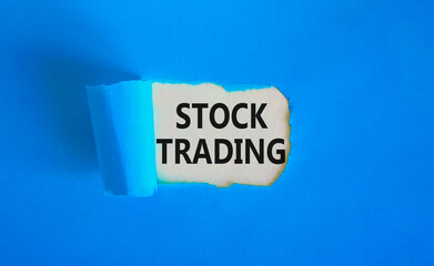 Stock trading symbol. Concept words Stock trading on beautiful white paper. Beautiful blue paper background. Business stock trading concept. Copy space.