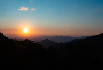 Scenic view at sunset time with silhouette mountain view at Phu Chi Fa Forest Park in Chiang Rai, Thailand.