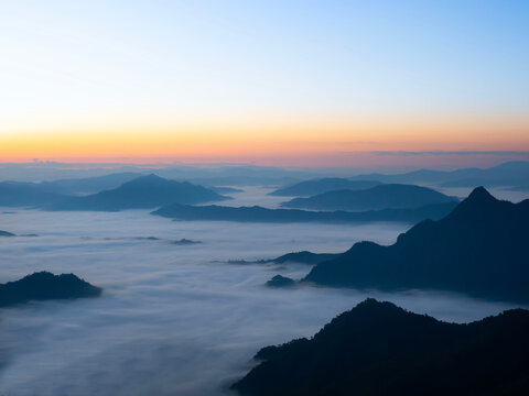 Scenic view of sea of clouds around mountain peaks at sunrise at Phu Chi Fa in Chiang Rai,Thailand.