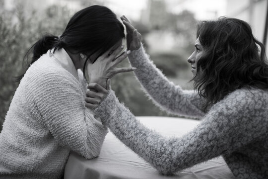 Daughter Talking To And Comforting Senior Mother Who Is Living With Mental Illness