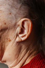 old grandmother's ear. photo of a woman's ear. wrinkled cheeks of an old grandmother