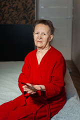 balding grandmother from chemotherapy with a comb. hair loss in a woman due to a cancerous tumor. a...