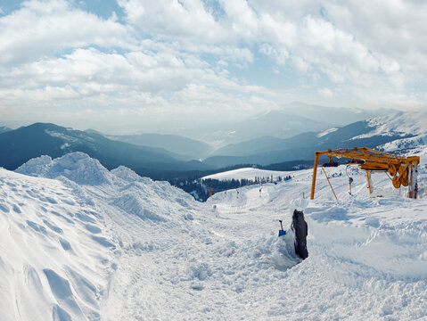 Snow-covered ski hoist ropeway (upper  terminal) and mountain landscape behind (Ukraine, Carpathian Mt's, Drahobrat ski resort).
