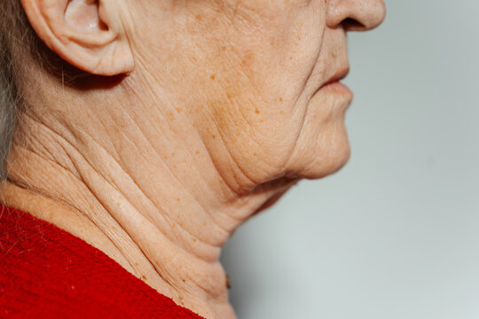 the flabby skin of an old grandmother. the woman has an old neck. wrinkled skin in an elderly person