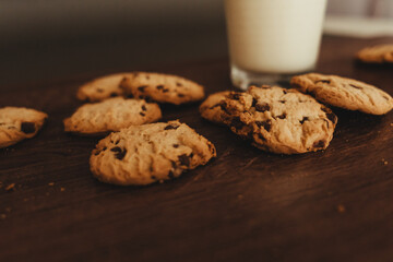 Savoring Simplicity: Homemade Cookies with a Glass of Milk on an Elegant Wooden Table.