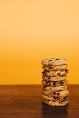 Delicious Breakfast: Cookies and Milk on a Wooden Table with an Orange Background.