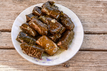 Dolmades - stuffed grape leaves  rolls  with rice the Greek way on wooden table .Stuffed greek wine leaves