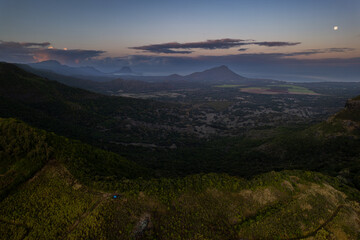 Fototapeta premium Aerial view of Trois mamelles mountain and the west coast of Mauritius island during a full moon at dawn