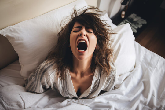 Screaming woman in bed expressing emotion after intimacy