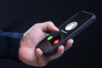 Incoming phone call from unknown number scammer caller. Man hold smartphone while receive...