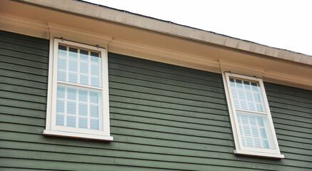 Suburban house, symbolizing mortgage burden amid financial inflation, with worried owners