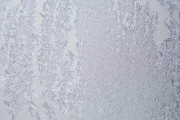 Pattern of ice frost on the glass of window. Winter background ant texture. Close up