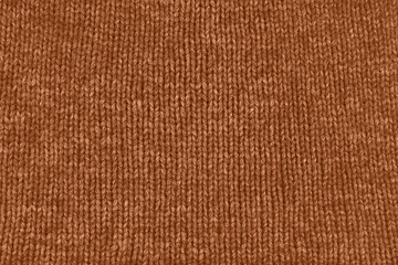 Background textile fabric with knitted wool texture in peach color.