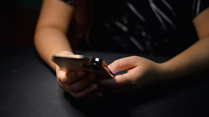 Close up female using her smartphone scroll through social media