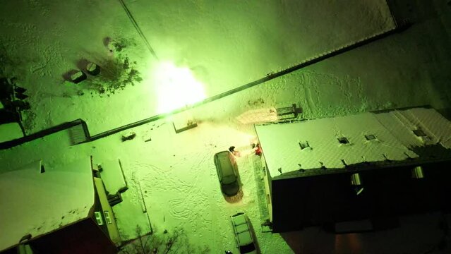 shards and flares fly through the air like a war zone. explosions near a residential building in winter. conquering territory as seen from a drone. these are permitted celebrations