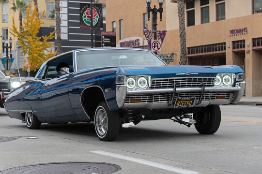 Lowrider, customized vintage Chevrolet, shown cruising on Colorado Boulevard on New Year's Eve in Pasadena, California, USA.