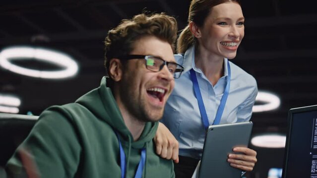 Couple cheerful colleagues rejoicing victory happy from success office closeup