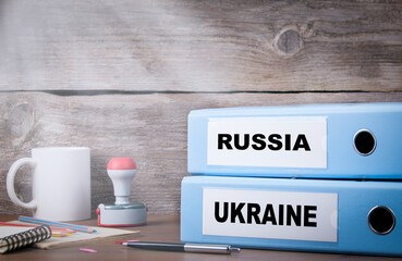UKRAINE and RUSSIA. Two binders on desk in the office. Business background