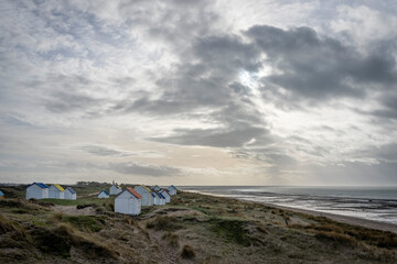 Gouville, France - 12 30 2023: View of colorful bathing wooden cabins of Gouville on the dunes.