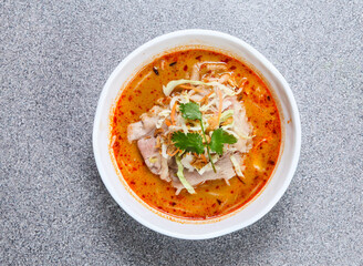 thai rice noodle in laksa soup with beef served in bowl isolated on grey background top view of hong kong food