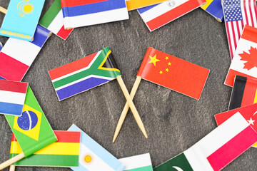Fototapeta na wymiar The concept is diplomacy. In the middle among the various flags are two flags - China, South Africa