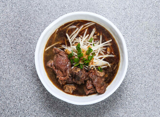 thai rice noodle in soup with beef flank served in dish isolated on grey background top view of...