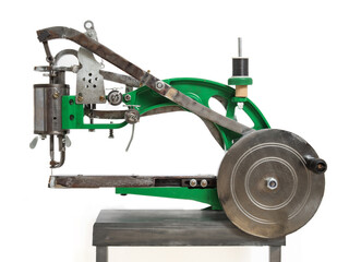 Sewing machine for shoemaker, leather worker and artisans. Isolated industrial sewing machine used for leather, canvas and fabrics Selective focus. White background