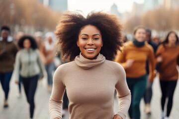 happy african american woman running on the background of a crowd of people